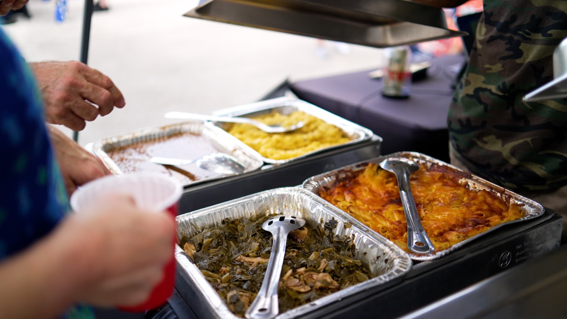 Hot sides and smoked meat at a staffed catering buffet