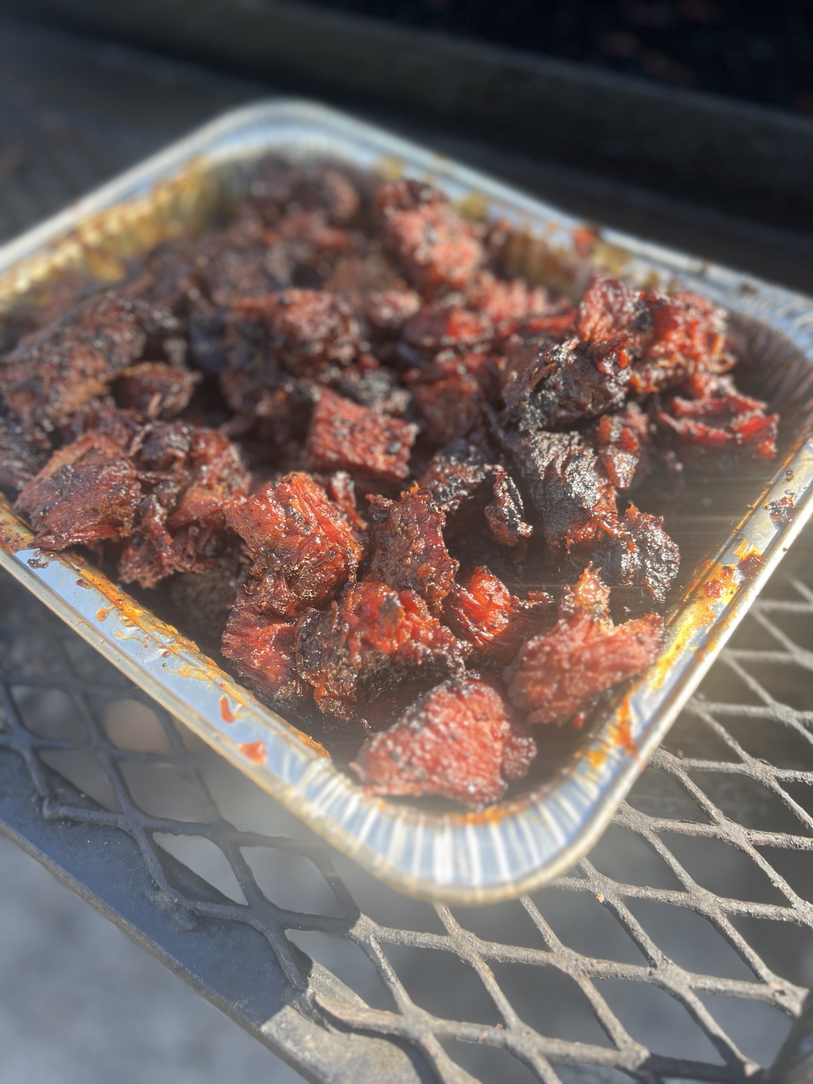 Eastside BBQ burnt ends with dark smoky bark in a foil tray